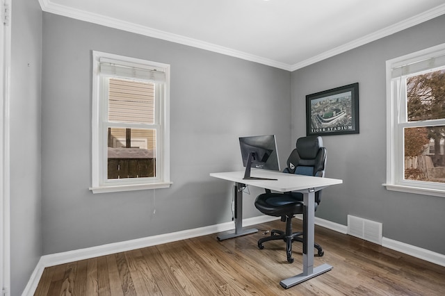 home office featuring baseboards, visible vents, wood finished floors, and ornamental molding