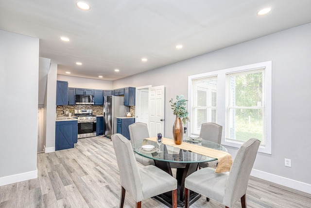 dining room with recessed lighting, light wood-type flooring, and baseboards