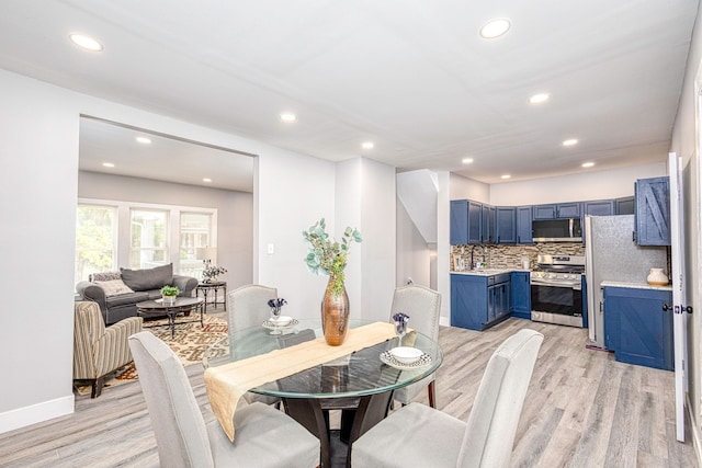 dining area featuring recessed lighting, light wood-style flooring, and baseboards