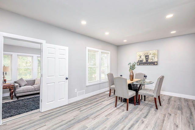 dining space featuring light wood-type flooring, a wealth of natural light, and recessed lighting