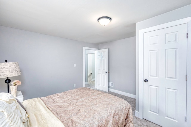 carpeted bedroom featuring visible vents and baseboards