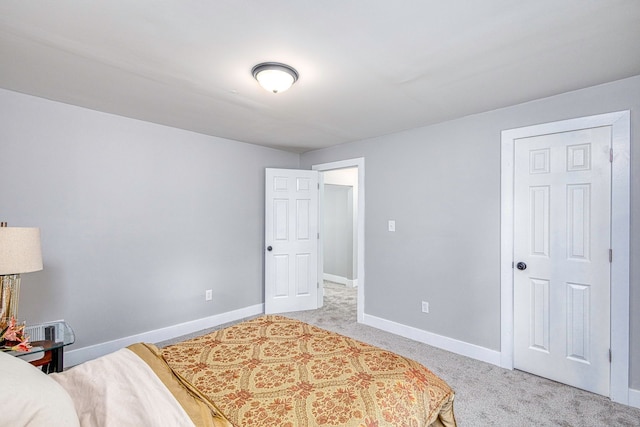 bedroom featuring baseboards and light colored carpet