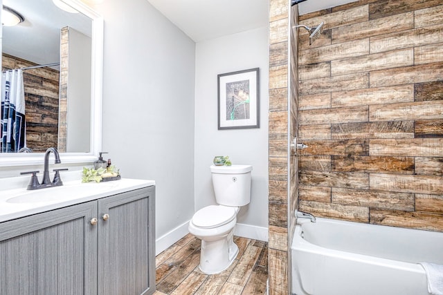 bathroom featuring shower / bath combination with curtain, toilet, vanity, wood finished floors, and baseboards