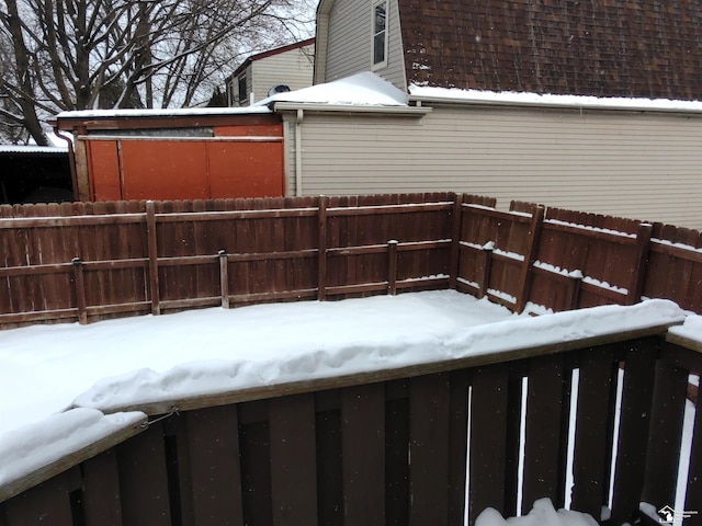 yard covered in snow with fence