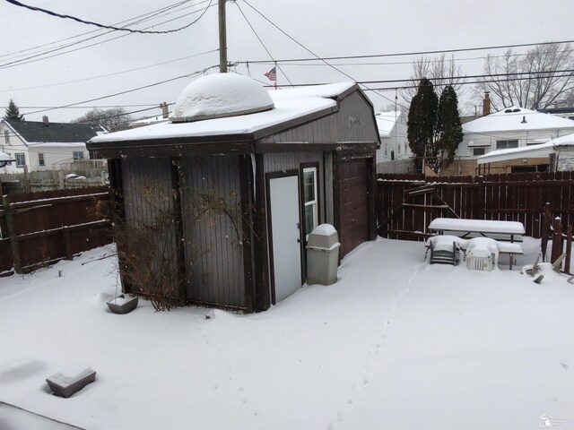 yard covered in snow featuring fence