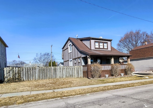 bungalow with a porch and fence