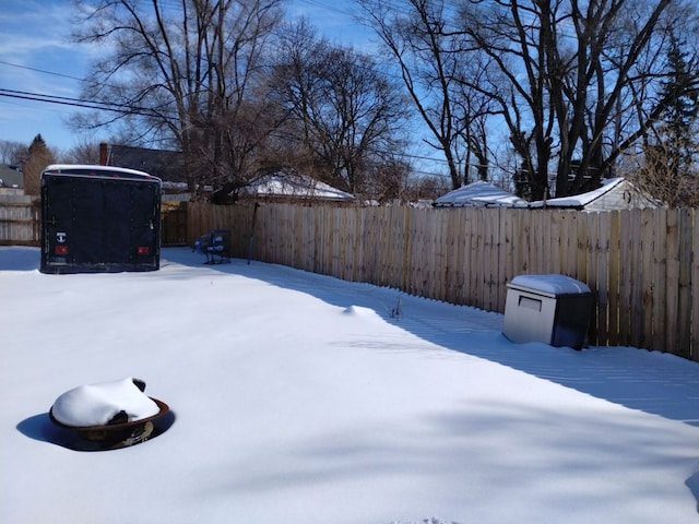 yard covered in snow with fence