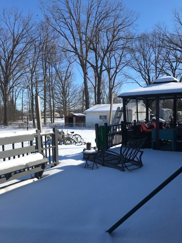 yard covered in snow with fence