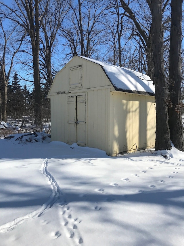 snow covered structure with an outdoor structure