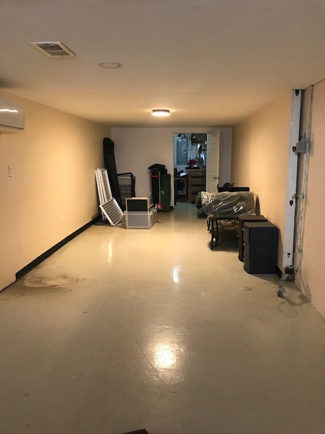 interior space featuring visible vents and an AC wall unit