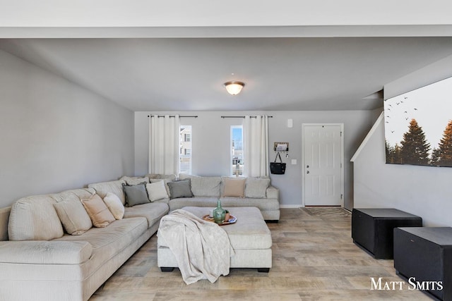 living area with light wood finished floors and baseboards