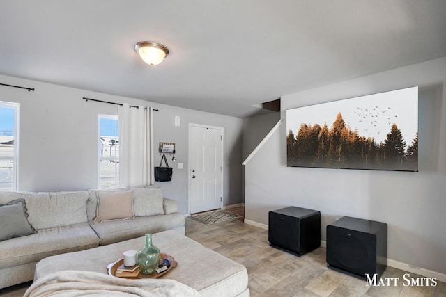 living area with light wood-style floors and baseboards