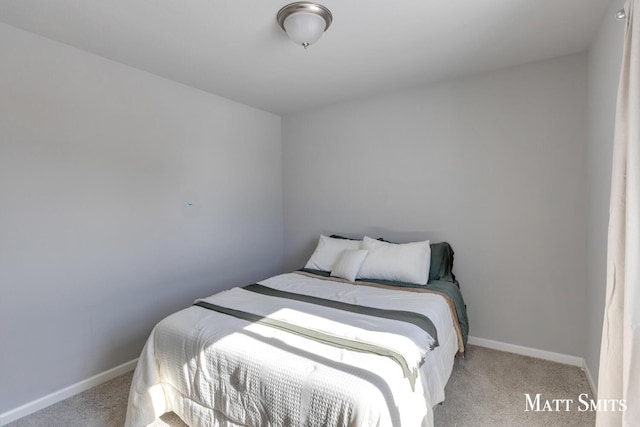 bedroom featuring baseboards and light colored carpet