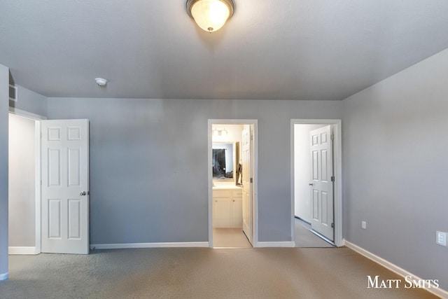 unfurnished bedroom featuring light carpet, connected bathroom, and baseboards