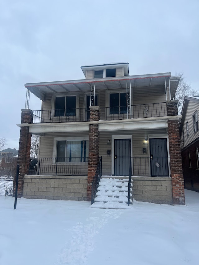 view of front of property with a balcony and a porch