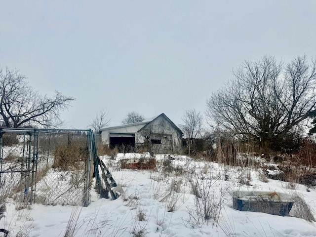 snowy yard with a garage