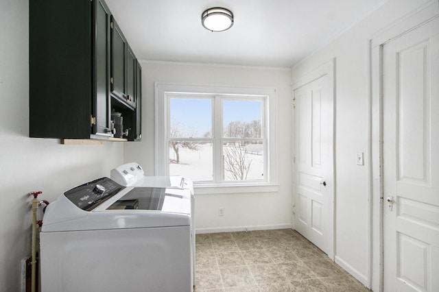 clothes washing area with washer and dryer, cabinet space, crown molding, and baseboards