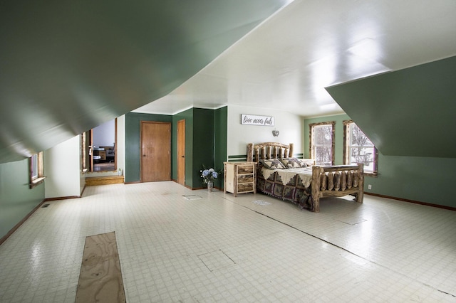 bedroom featuring baseboards and vaulted ceiling