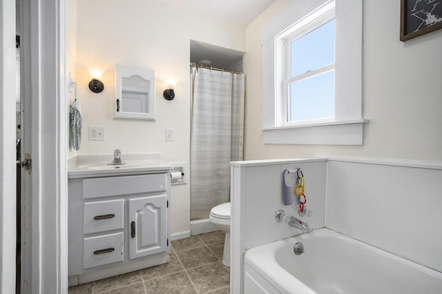 full bath featuring toilet, tile patterned floors, a garden tub, and vanity