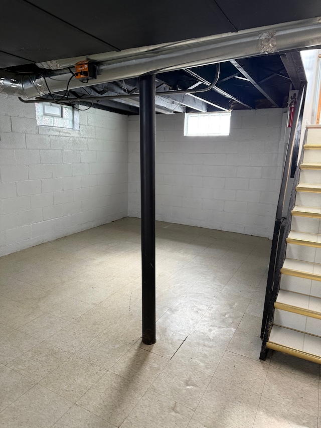 basement with stairs and tile patterned floors