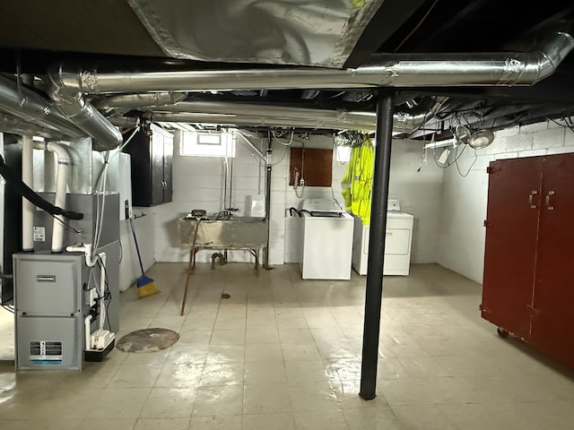 basement with heating unit, light floors, and a sink