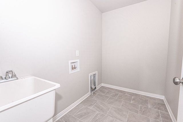 laundry room with baseboards, laundry area, a sink, and hookup for a washing machine