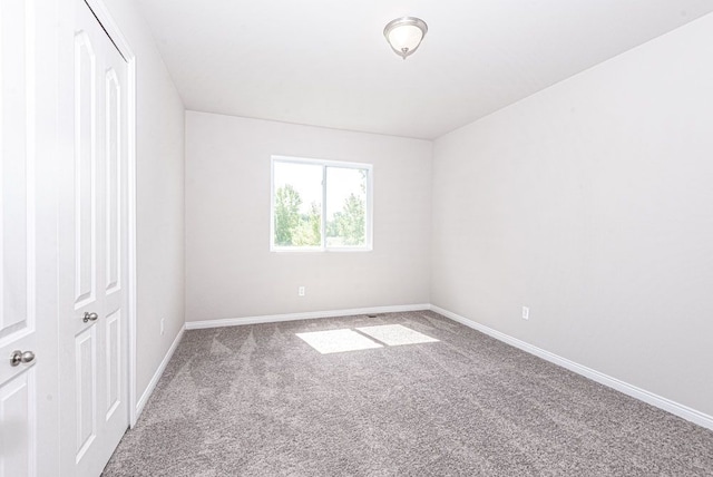 empty room with carpet floors and baseboards