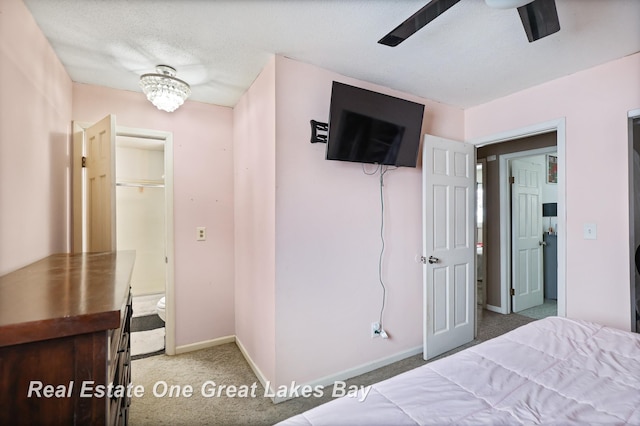 bedroom with a textured ceiling, baseboards, and carpet flooring