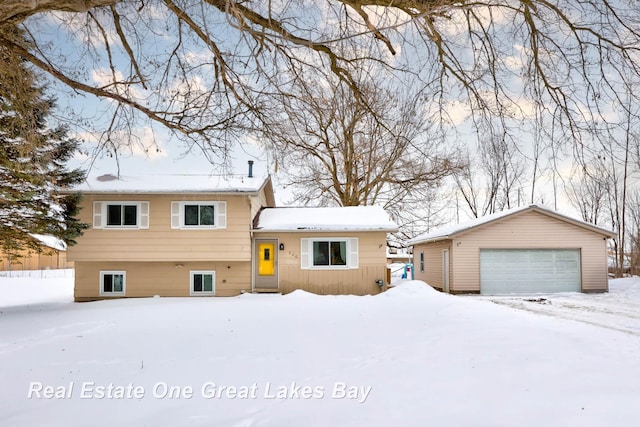 split level home featuring a garage and an outbuilding