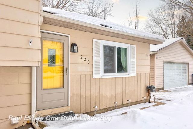 view of snow covered property entrance