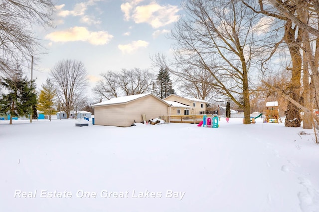 view of snow covered exterior with a playground