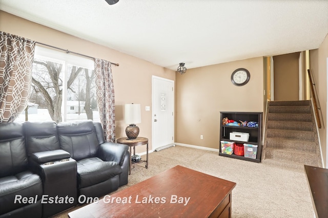 carpeted living room featuring baseboards and stairs