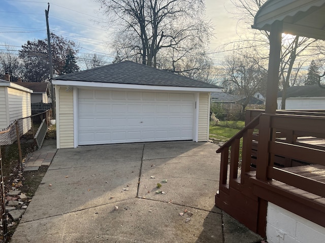 detached garage featuring fence