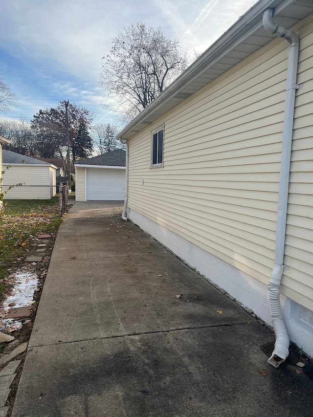 view of side of home with a garage and an outdoor structure