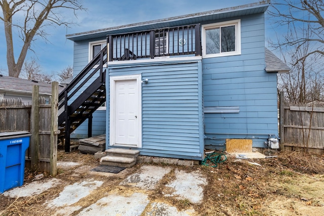 back of house with stairs and fence