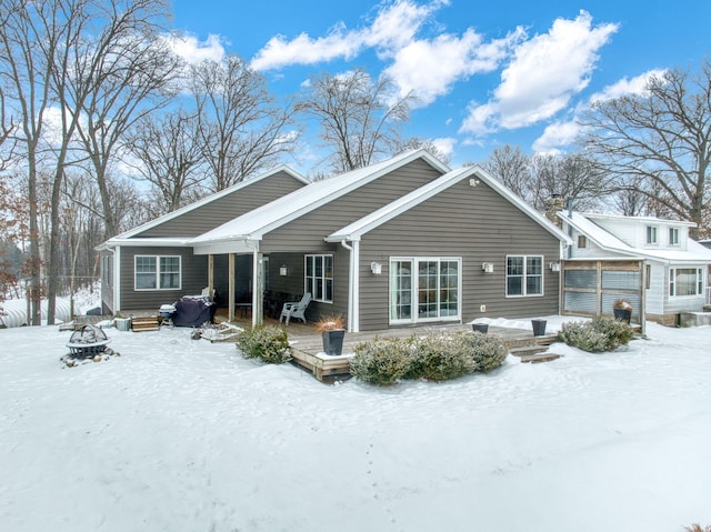 view of snow covered rear of property