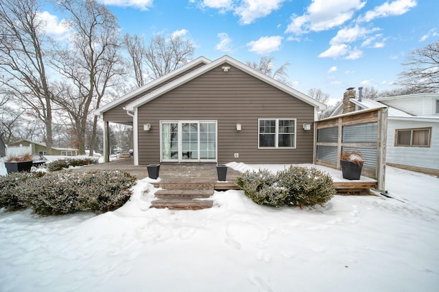 view of snow covered back of property