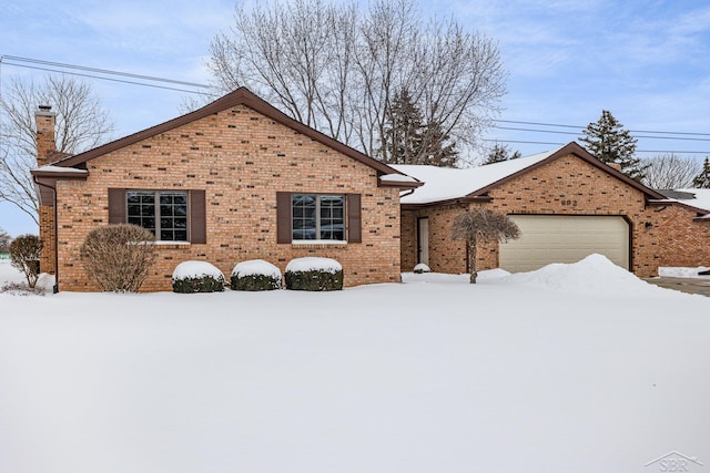 ranch-style house featuring a garage, brick siding, and a chimney