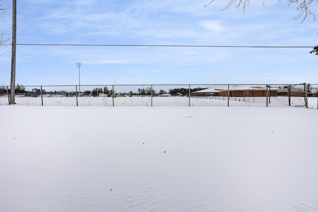 snowy yard with fence