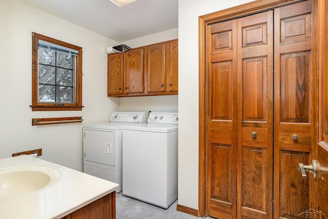 laundry area with a sink and washer and dryer