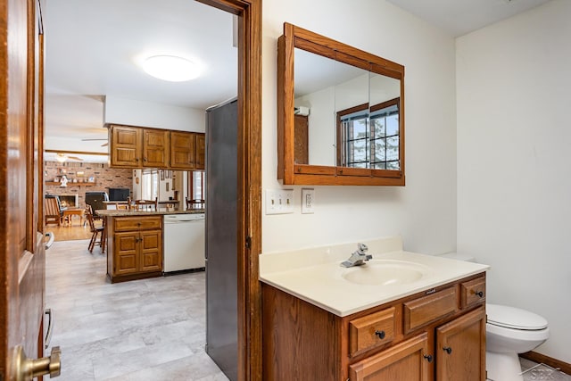 bathroom with toilet, ceiling fan, and vanity