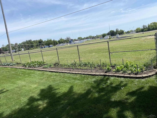 view of yard featuring a rural view and fence