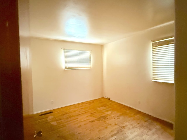 spare room with visible vents and a healthy amount of sunlight