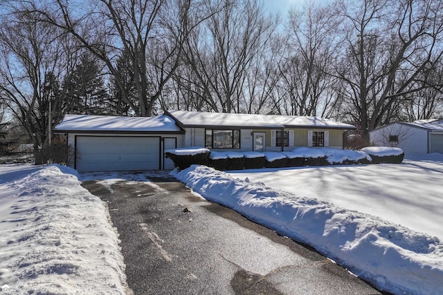 view of front of home with a garage and aphalt driveway