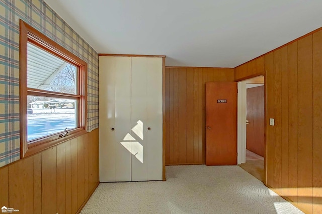 bedroom with light carpet and a closet