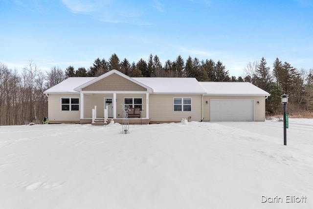 ranch-style home featuring covered porch and an attached garage