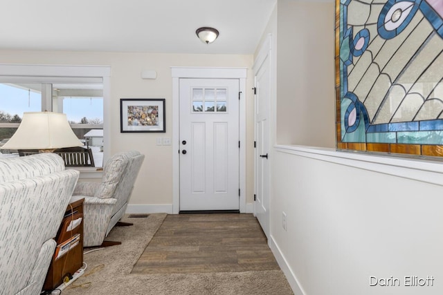 entryway with visible vents, baseboards, and wood finished floors