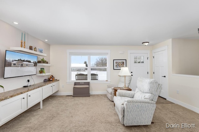 sitting room featuring baseboards, recessed lighting, and light colored carpet