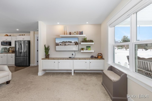 living room featuring light carpet, baseboards, and recessed lighting