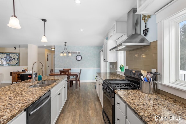 kitchen with white cabinets, dishwasher, wall chimney exhaust hood, black range with gas stovetop, and a sink